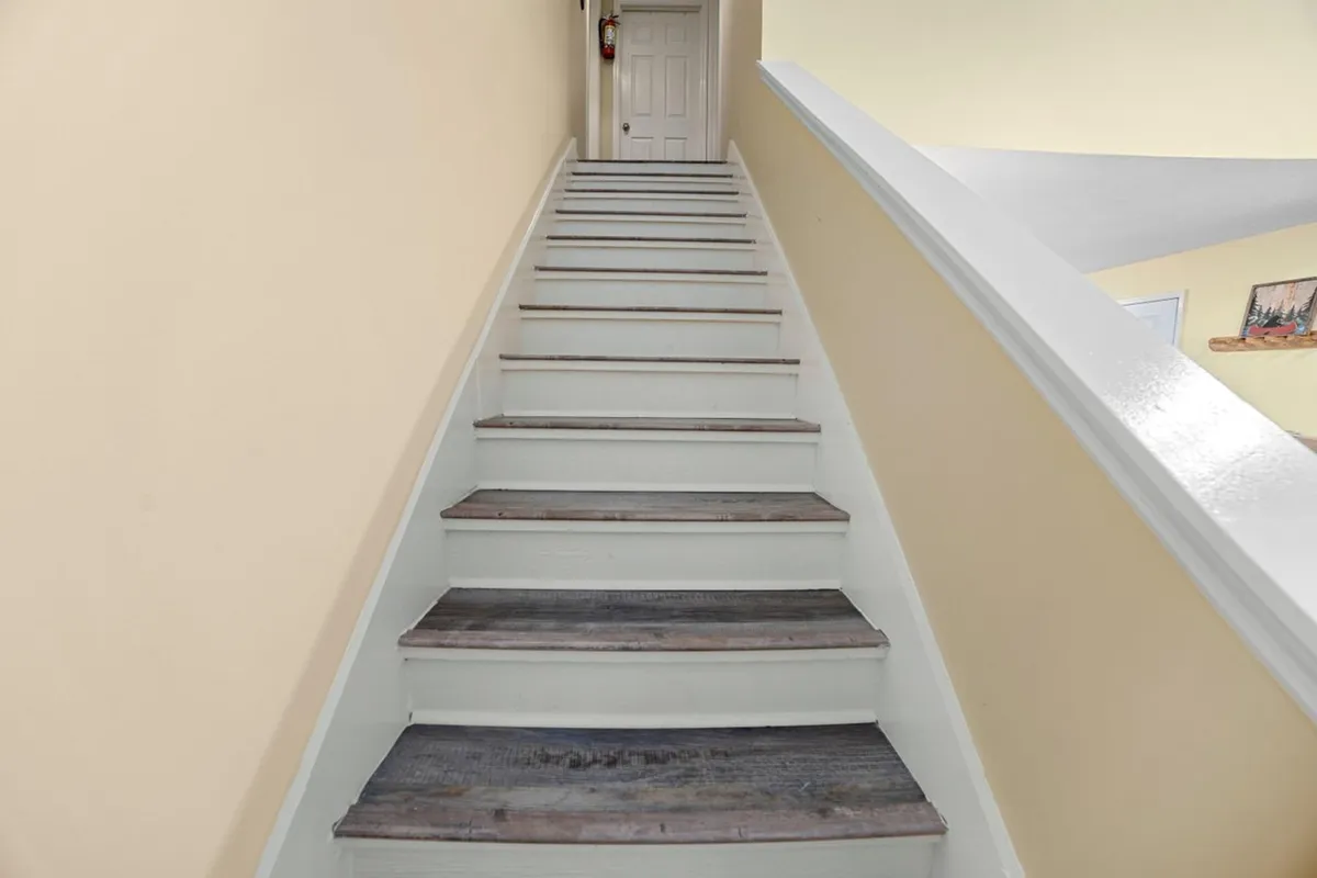 This interior image features a staircase and a welcoming doorway, hinting at an inviting entry point and the anticipation of moving between spaces. The scene captures the mood of arriving and preparing to embark on the day's adventures, with a sense of curiosity and excitement for what lies beyond.